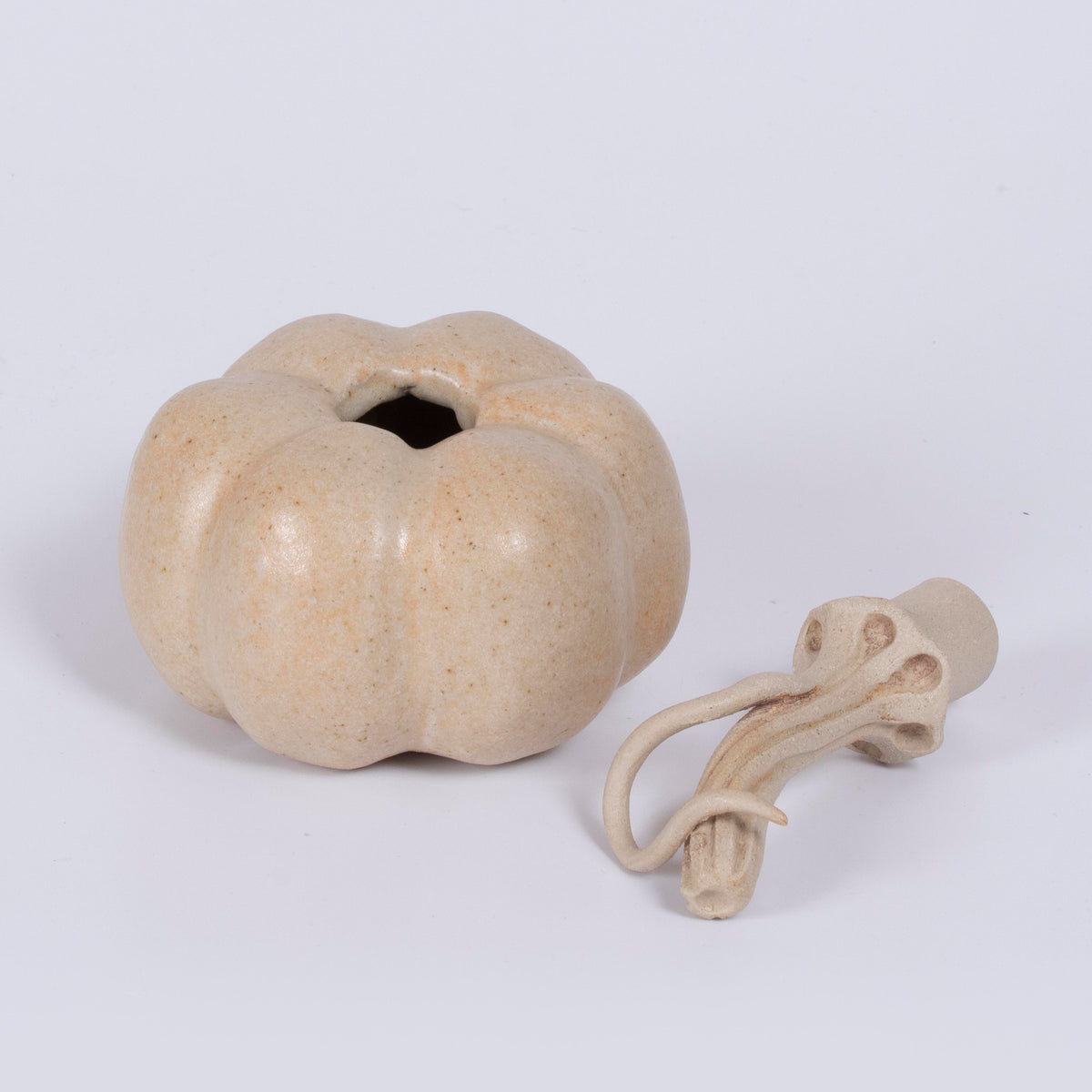 Side view of ceramic pumpkin sculpture by Gerry Unsworth, intricate twisted stalk with curled tip, handmade signed studio pottery