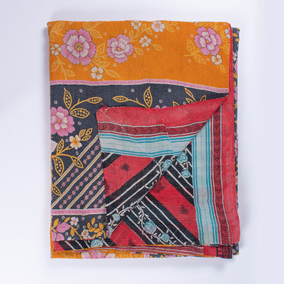 Handcrafted Vintage Kantha Quilt – In Full Bloom folded, showing both reversible sides – dahlia on orange side and bold blue rose stripe reverse