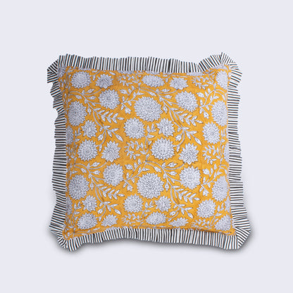Hand Block Print Dahlia Cushion with Stripe Frill & Feather Insert – Saffron flat product shot on light grey background showing the full cushion with all-over white dahlia and trailing leaf block print on vibrant saffron yellow cotton with black and white candy stripe pleated frill