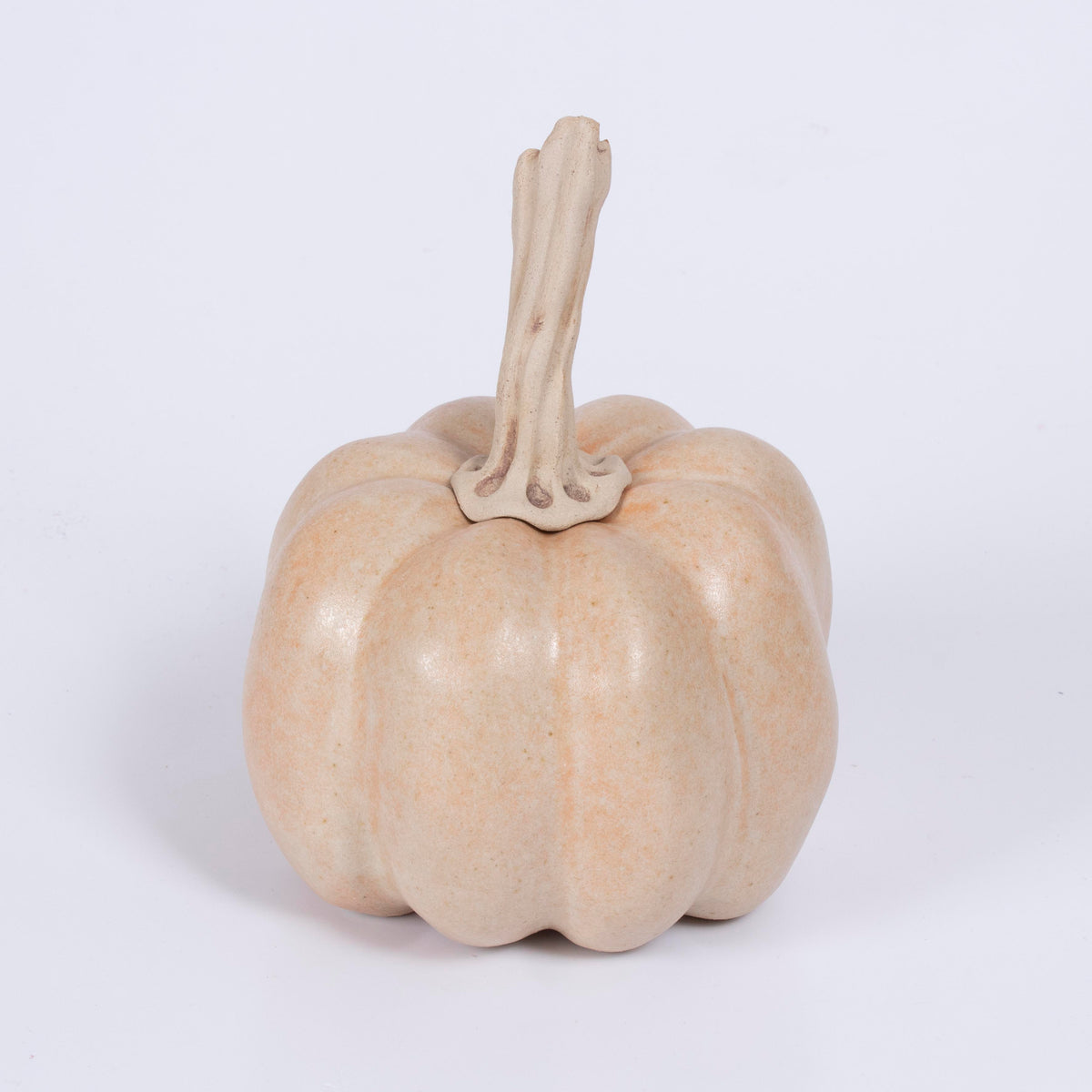 Handmade ceramic pumpkin by Gerry Unsworth, pale blush-pink glaze, low and wide form with short straight stalk, 13.5cm x 18cm, signed British studio pottery